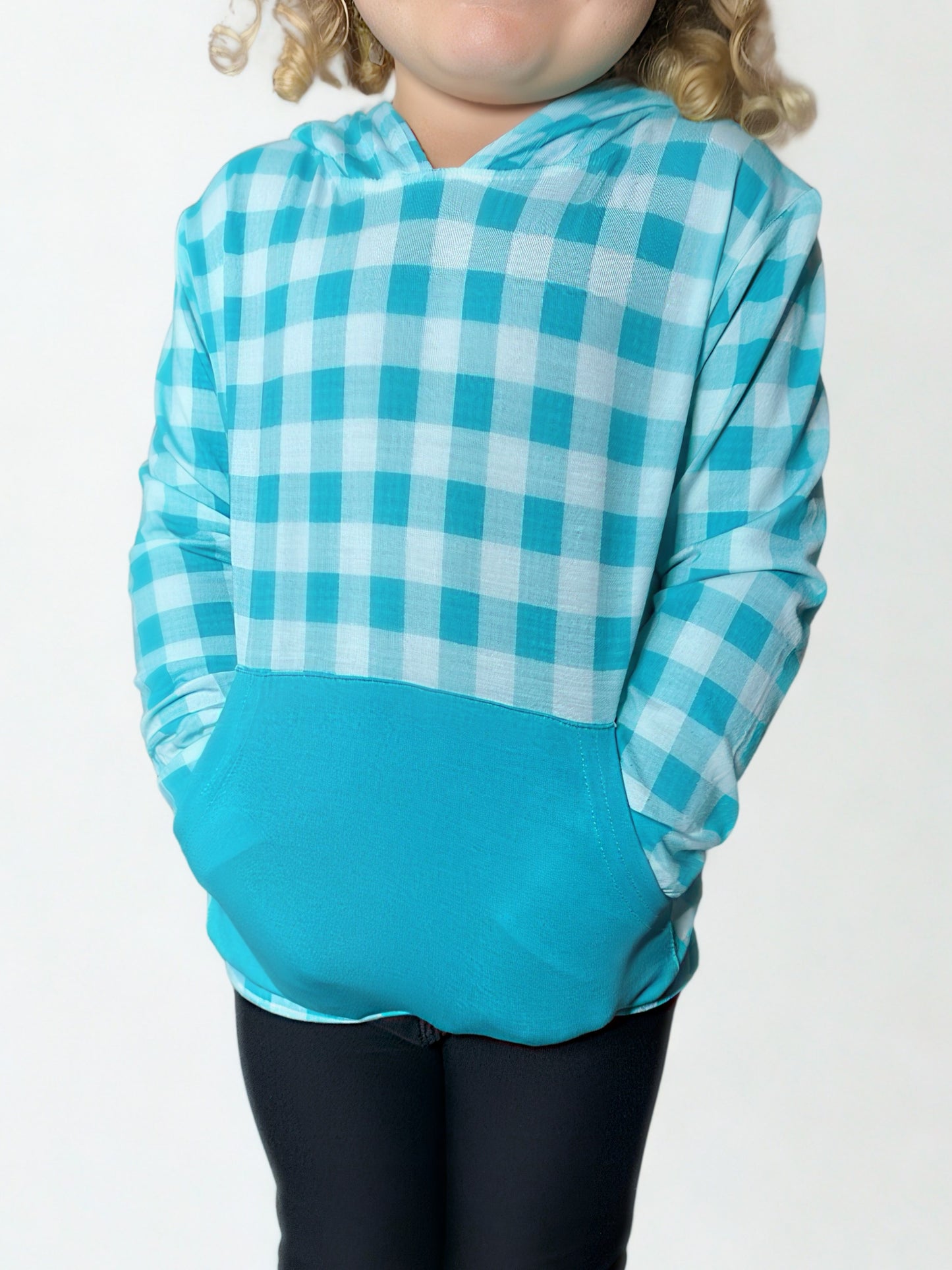 Child wearing a blue and white checkered hoodie on a plain background