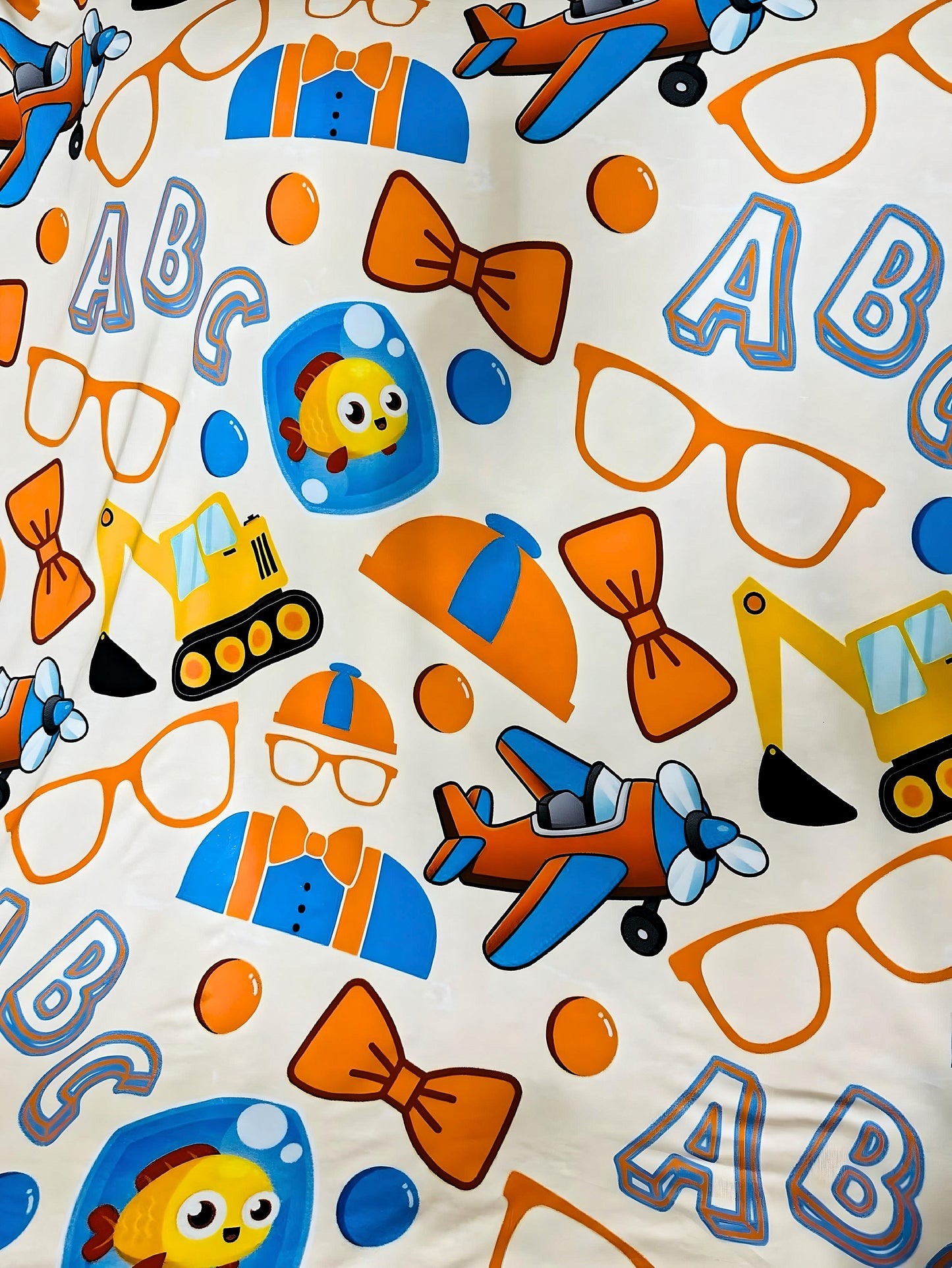 Playtime Adventures Bamboo Blanket with colorful toddler design featuring planes, construction vehicles, bow ties, and ABC letters on soft double-layered bamboo fabric