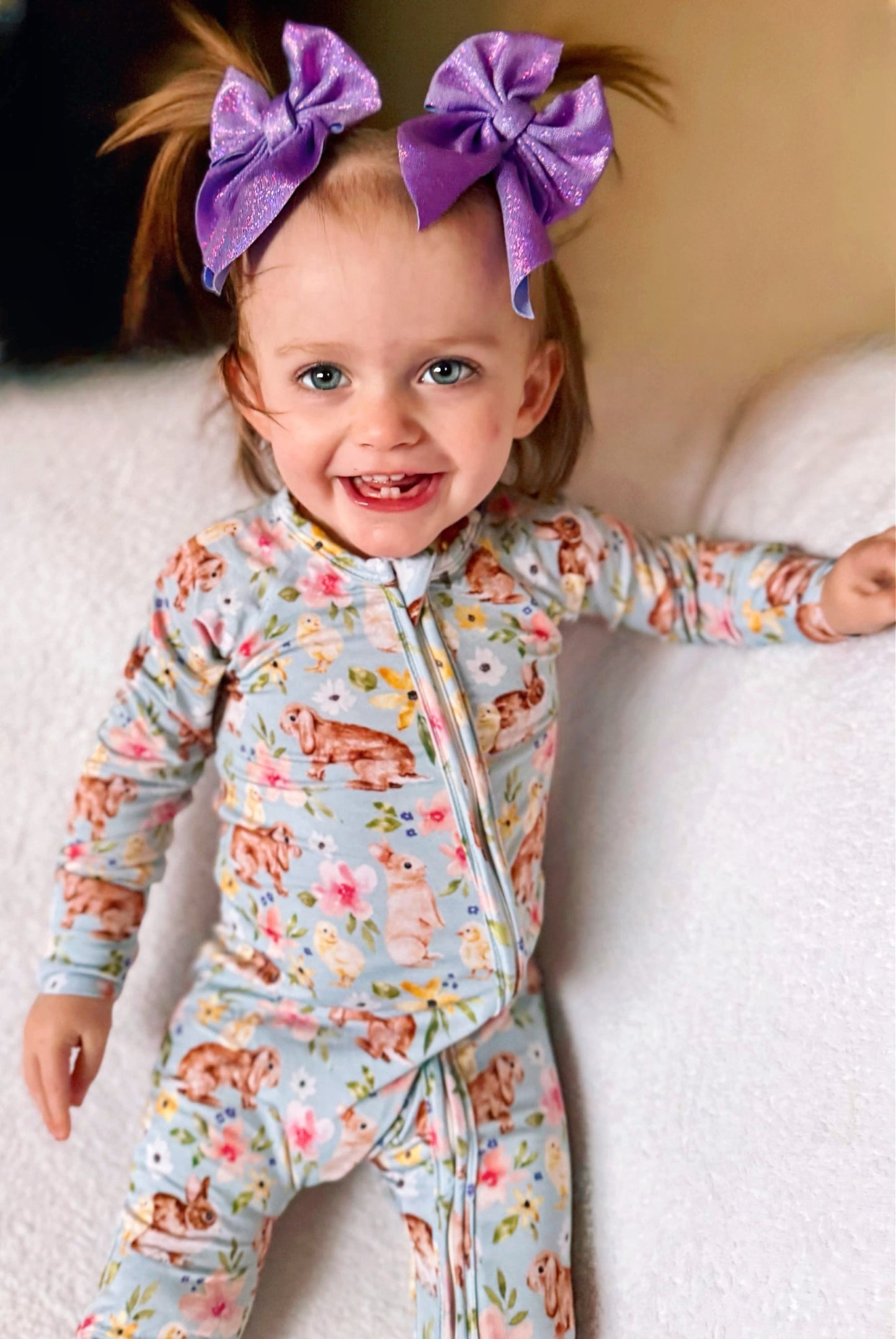 Toddler wearing Bunny Blooms Romper with playful bunny and floral print.