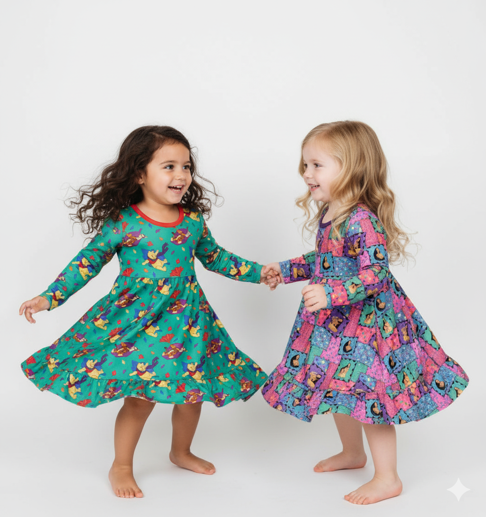 Two children wearing colorful dresses with long sleeves on a white background