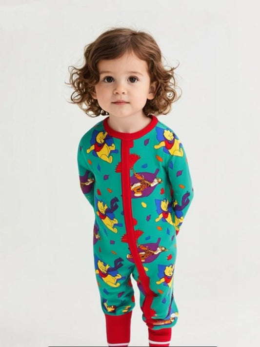 Child wearing a colorful onesie with cartoon characters on a white background