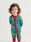 Child wearing a colorful onesie with cartoon characters on a white background