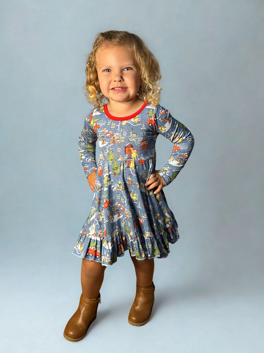 Child wearing a christmas dress with long sleeves on a plain background