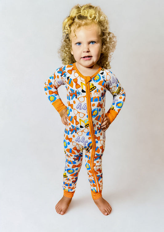 Playtime Adventures Bamboo Romper with colorful design and double-sided zipper, worn by toddler.