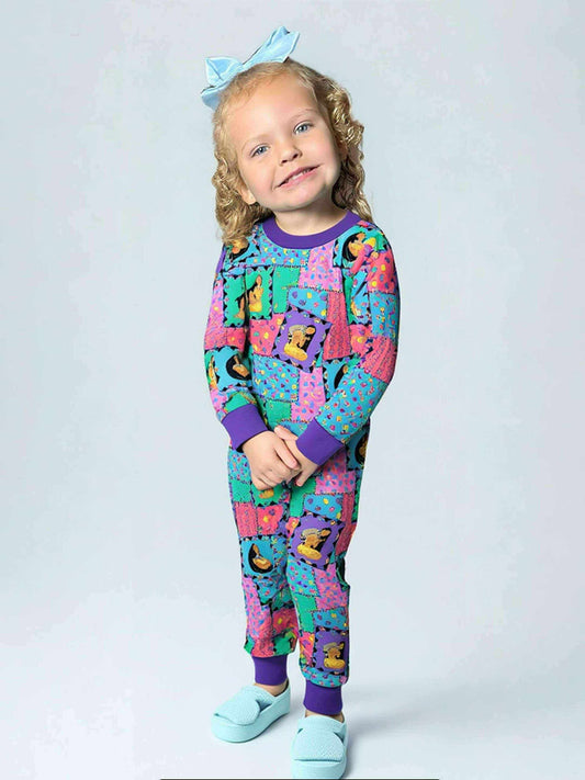 Child wearing colorful pajamas with a pattern on a white background