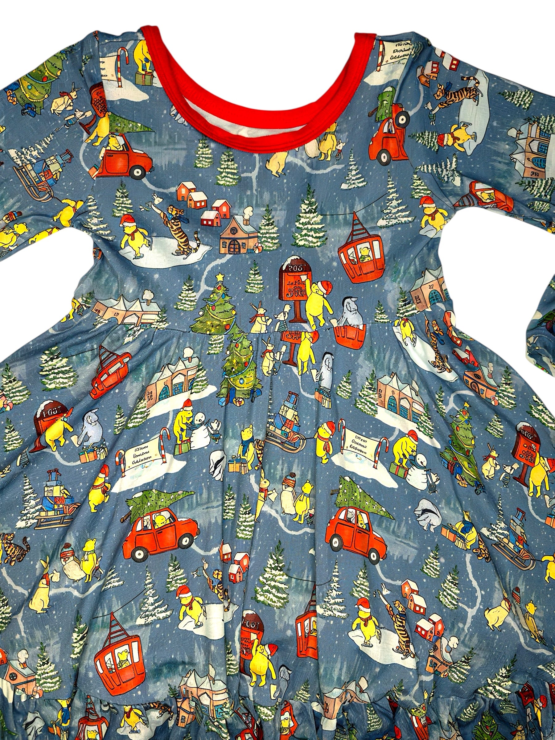Children's dress with winter scene print featuring snowmen, cars, and trees on a blue background.