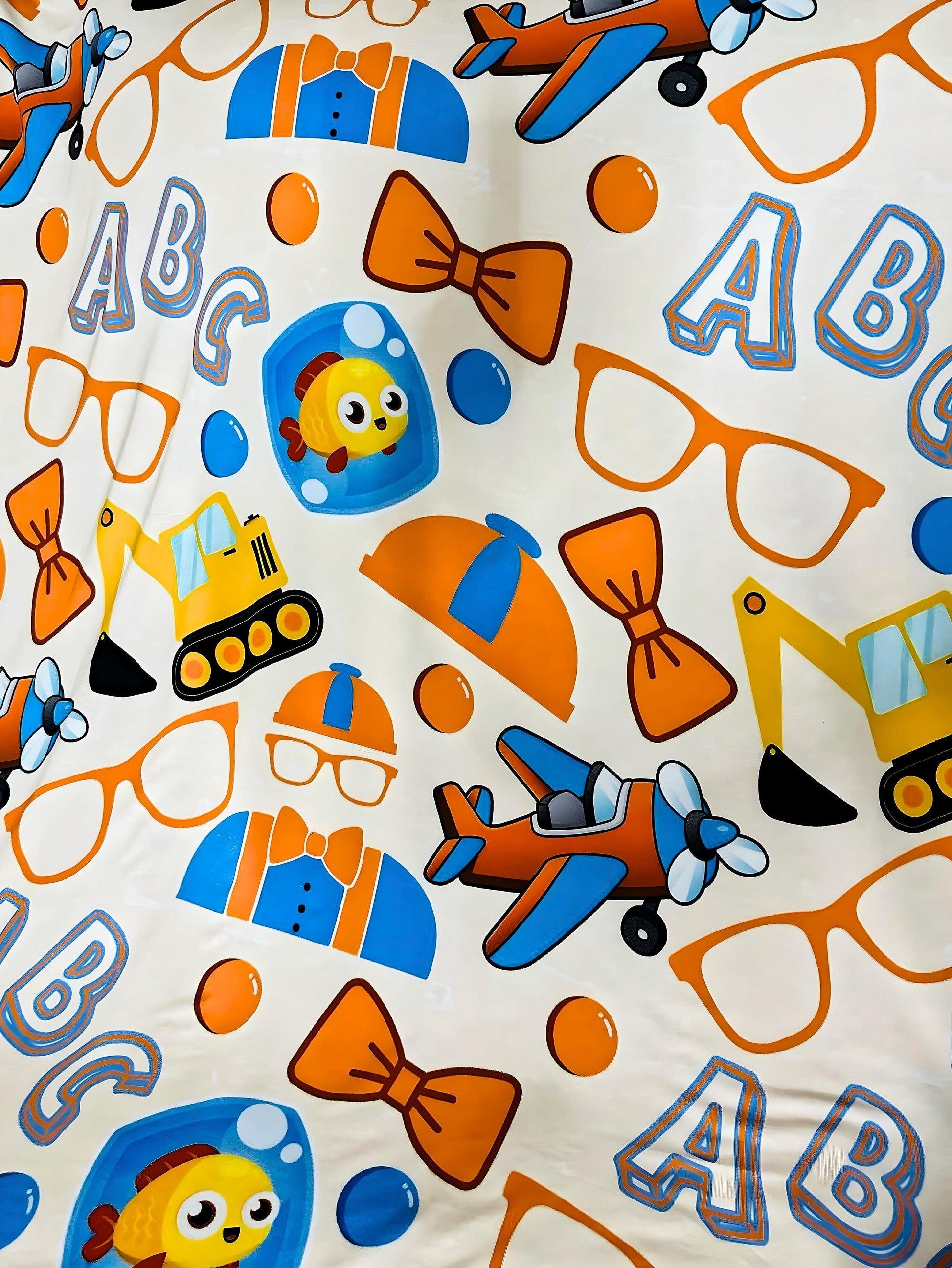Playtime Adventures Bamboo Blanket with colorful toddler design featuring planes, construction vehicles, bow ties, and ABC letters on soft double-layered bamboo fabric