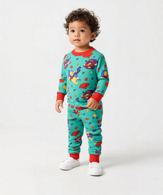Child wearing a colorful pajama set with cartoon characters on a white background