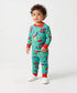 Child wearing a colorful pajama set with cartoon characters on a white background