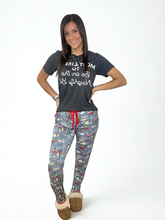 Woman wearing a dark gray t-shirt with text and bamboo christmas pajama bottoms