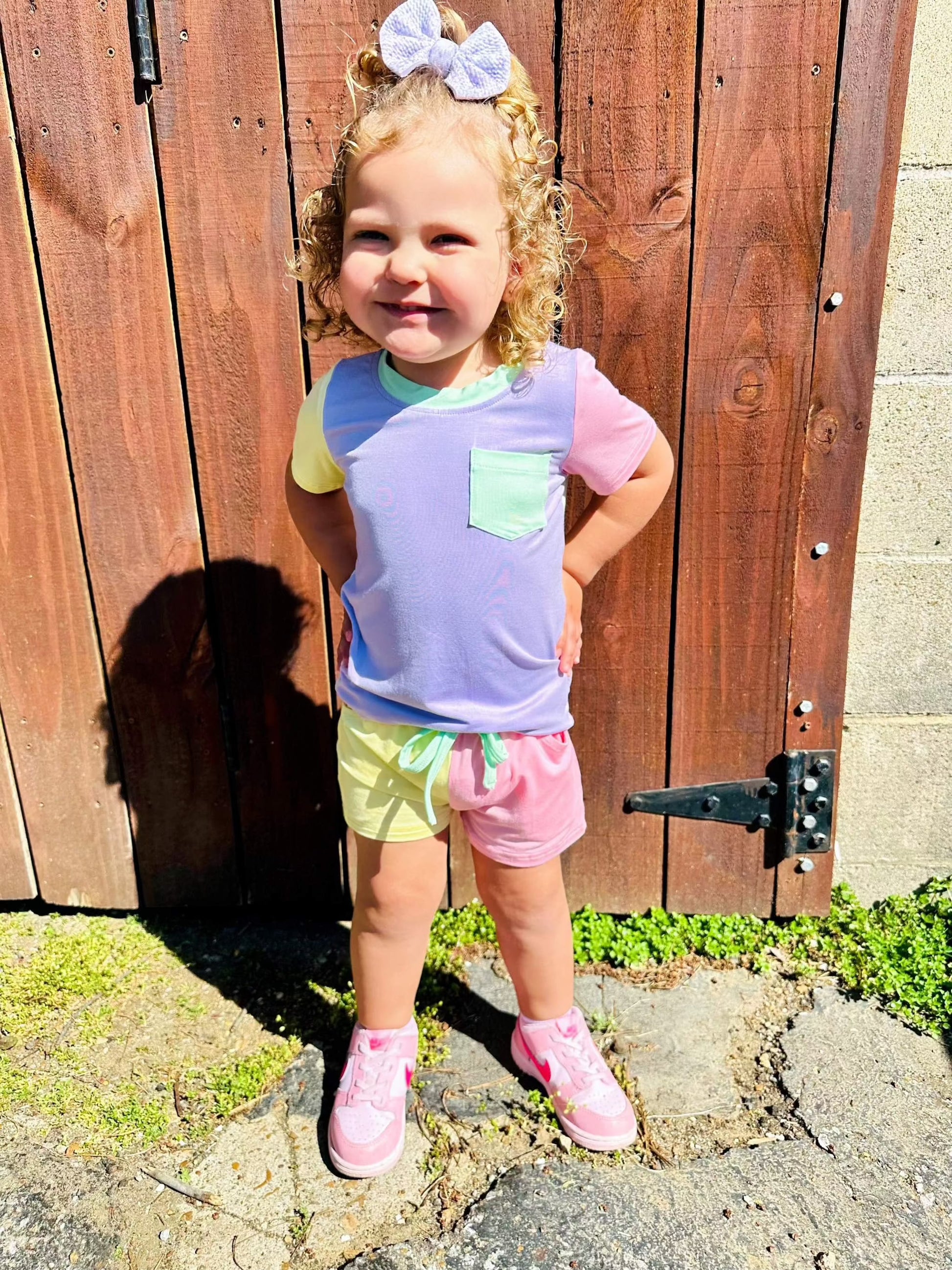 Color block purple and green bamboo pocket tee and short set for kids with drawstring shorts and pocket detail.