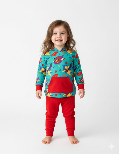 Child wearing a colorful pajama set with a pattern on a white background