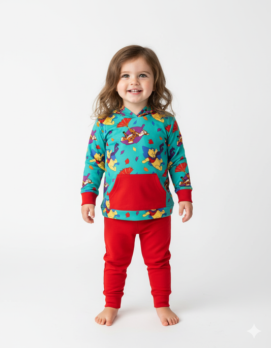 Child wearing a colorful pajama set with a pattern on a white background
