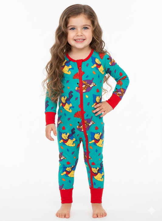 Child wearing colorful pajamas with cartoon characters on a white background