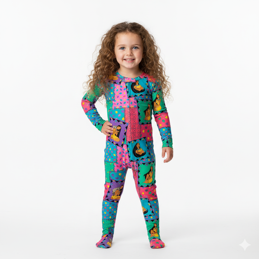 Child wearing a colorful onesie with cartoon characters on a white background